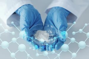 Person with gloves holding powder in a petri dish