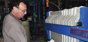 man cleaning a wastewater treatment system