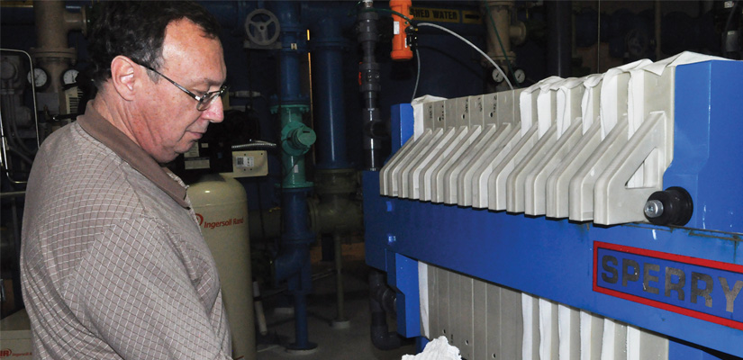 man cleaning a wastewater treatment system